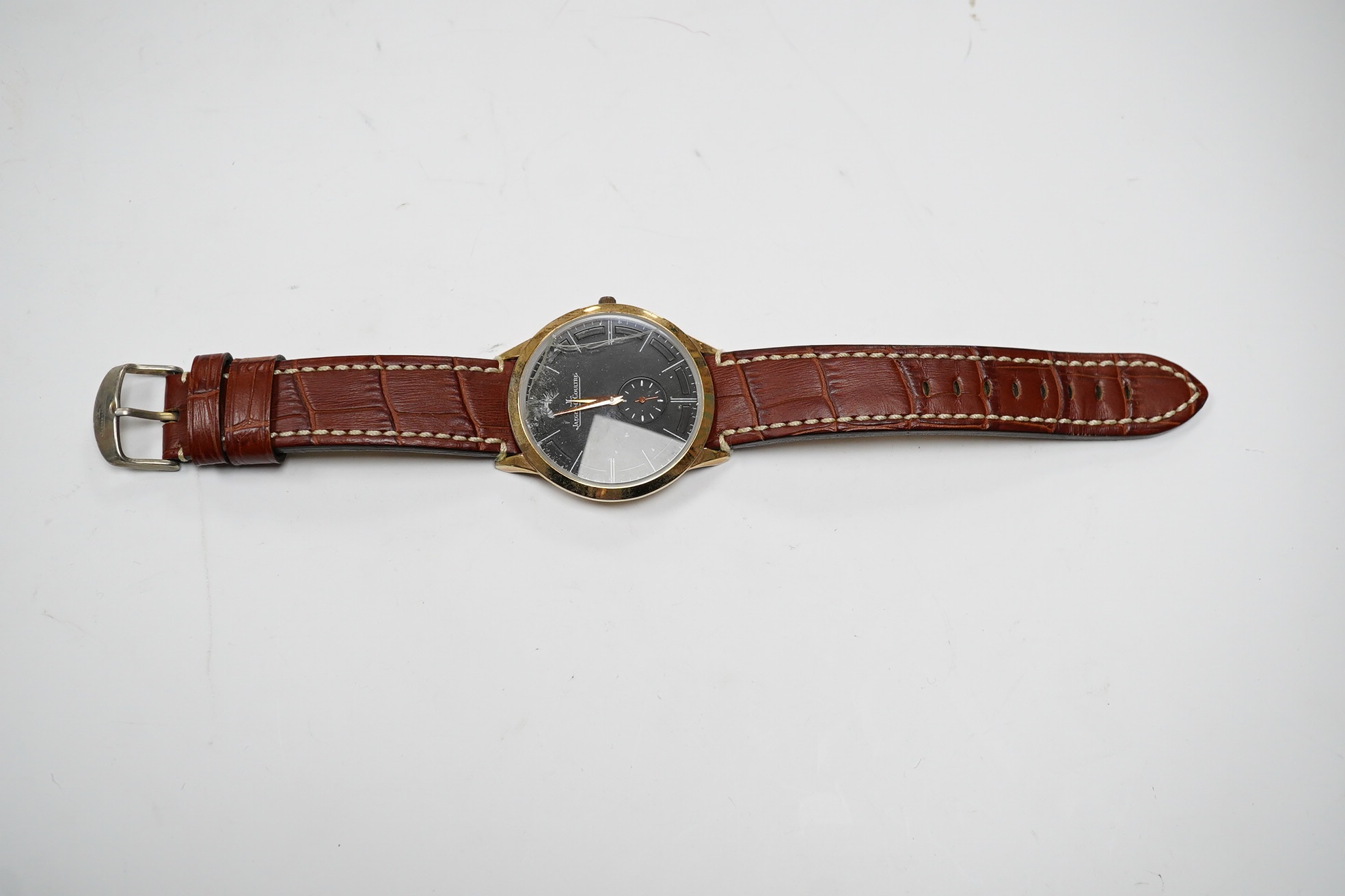 A gentleman's steel and gold plated Jaeger LeCoultre Master Grand Ultra Slim manual wind wrist watch, with black dial and subsidiary seconds, case diameter 45mm, on an associated leather strap. Condition - poor.